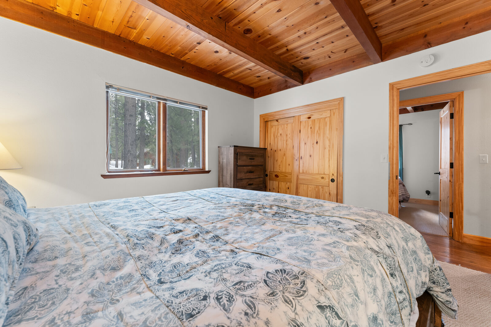 Bright bedroom with forest views